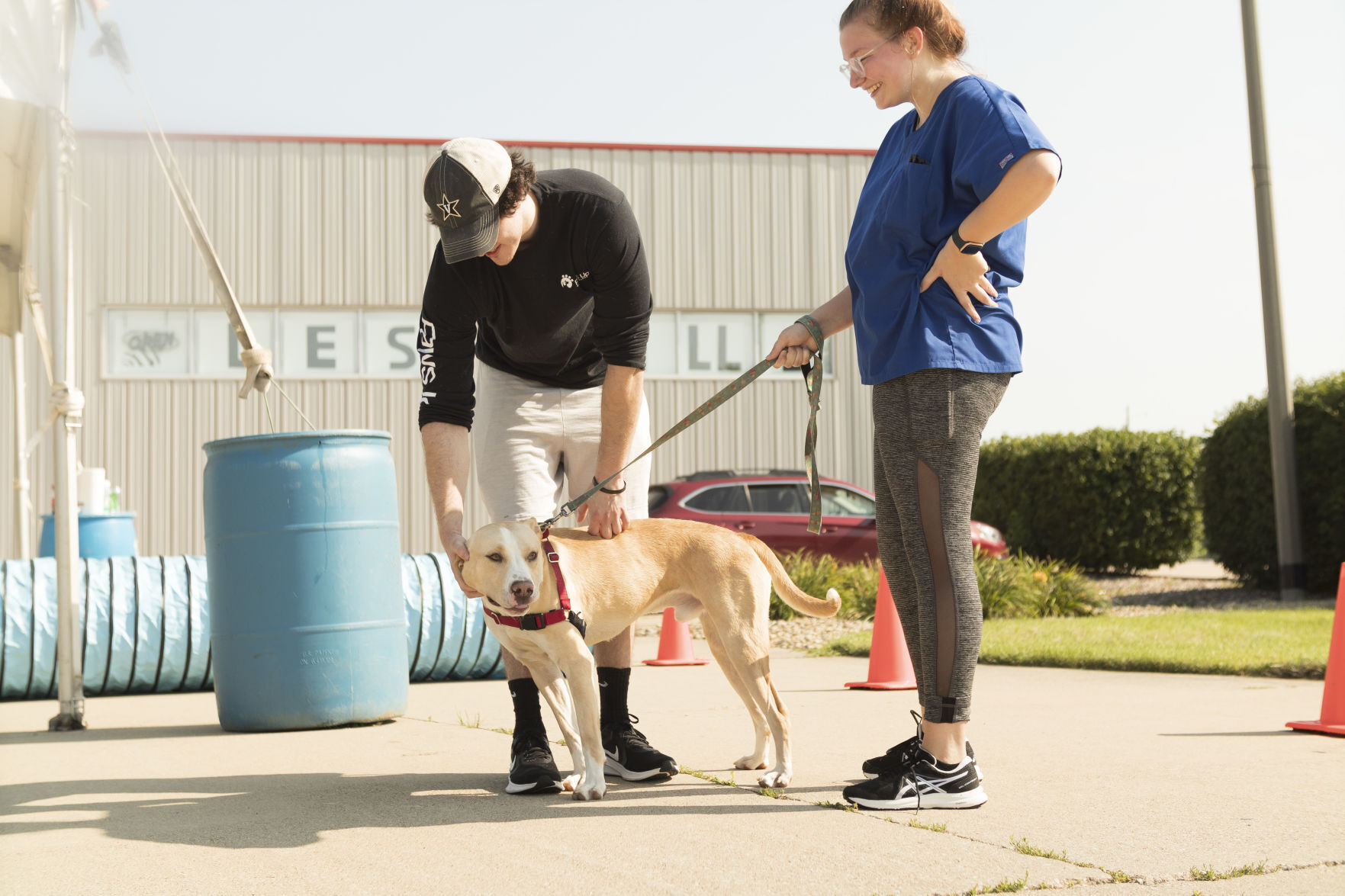 Trey McCormick pets Barney as Taylor Olomon watches